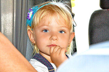 A little girl with beautiful eyes looks into the camera.