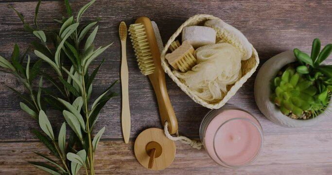 Spa utensils on a wooden background. Natural and ecological sponge and comb 