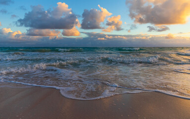 Colorful clouds and shore water on a sunrise