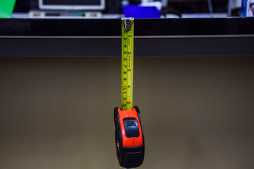 measuring instrument Yellow-red measuring tape, hanging, hanging vertically..