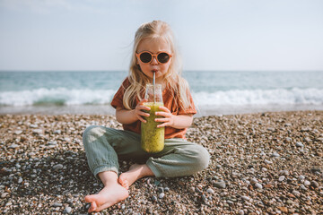 Child drinking smoothie on beach healthy lifestyle vegan breakfast organic food summer vacations