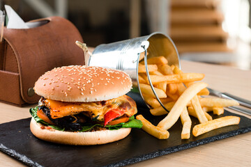 Set of burgers with french fries and ketchup sauce. Big hamburgers and french fries. Fast food set...