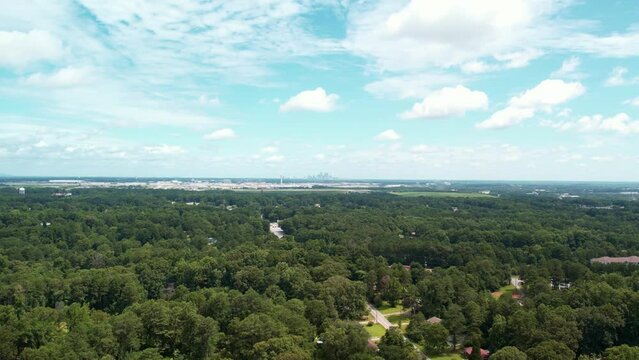 Far away aerial drone pull away from airport city