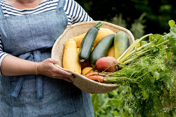 woman holding bowl of fresh garden produce