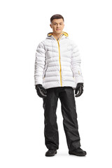 Fototapeta premium Full length portrait of a guy in a white winter jacket and pants