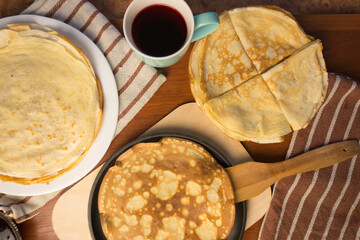 Pancake week. Preparation of dough for baking delicious and ruddy pancakes from the ingredients eggs, flour, butter and milk. Maslenitsa traditional Russian festival meal.