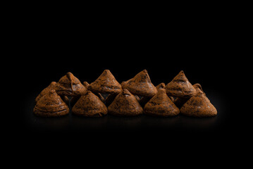Chocolate truffles on a black background.