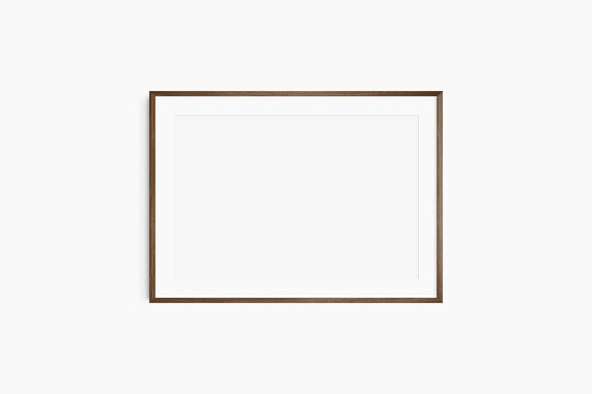 Horizontal frame mockup 7:5, 70x50, A4, A3, A2, A1 landscape. Single dark brown walnut wood frame mockup. Clean, modern, minimalist, bright. Passepartout/mat opening in 3:2 aspect ratio.