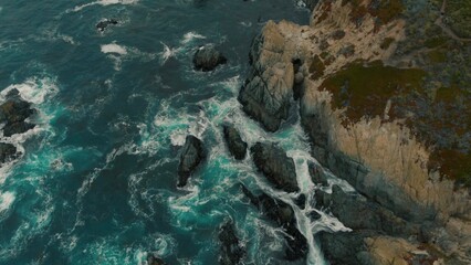 Crystal clear turquoise water, waves crashing on the rocky shore, and the ruins