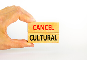 Cancel cultural symbol. Concept words Cancel cultural on wooden blocks on a beautiful white table white background. Businessman hand. Business and cancel cultural concept, copy space.