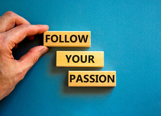 Follow your passion symbol. Concept words Follow your passion on blocks on beautiful blue table blue background. Businessman hand. Business, motivation and follow your passion concept. Copy space.