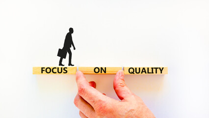 Focus on quality symbol. Concept words Focus on quality on blocks on beautiful white table white...