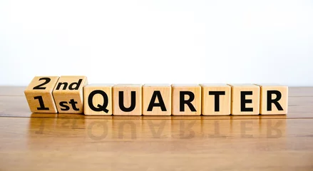 Foto op Plexiglas From 1st first to 2nd second quarter symbol. Turned wooden cubes and changed words 1st quarter to 2nd quarter. Beautiful wooden table white background. Business happy 2nd quarter concept. Copy space. © Dzmitry