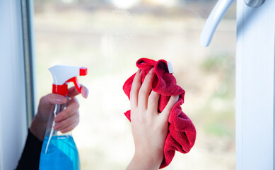 The young woman washing window