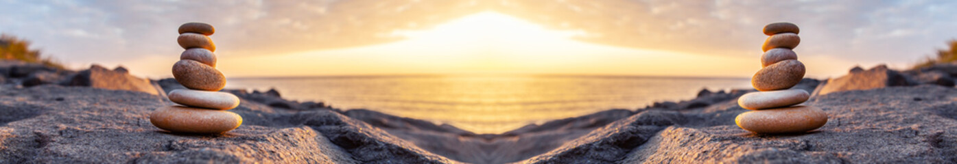 Stones pyramid on the seashore at sunset