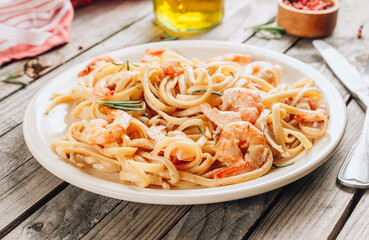 Pasta tagliatelle with shrimps in creamy sauce