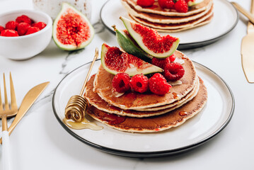 Homemade classic american pancakes with almond, fresh raspberries and figs