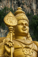 Close up of face of the Murugan Statue (Tugu Dewa Murugga) in Batu Caves, Selangor, Kuala Lumpur. Tallest statue of a Hindu deity in Malaysia made with 300 liters of Gold Paint and 350 tons steel bar.