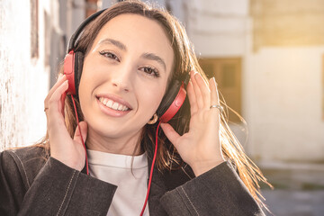 portrait of Millennial woman enjoying music in headphones