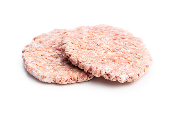 Frozen hamburger meat. Raw beef patties isolated on white background.