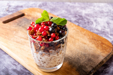 Fresh summer currant berries in a glass. Various currants on the kitchen board. Berry snack.