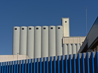 Industrial silo`s behind a fence in the harbor of Cadiz, Andalusia, Spain 