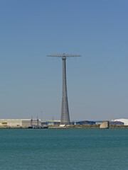 Fototapeta na wymiar Harbour of Cadiz with one of the famous pylons supporting a power line over the bay of Cadiz