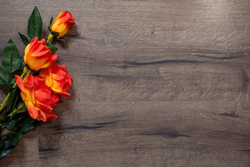 Fototapeta na wymiar Floral decorative background with wooden planks. Yellow and red rose decoration.