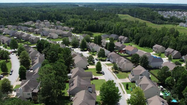 Flying over an American lush green suburban neighborhood.