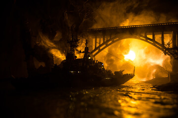 Silhouettes of a crowd standing at blurred military war ship on foggy background. Selective focus.