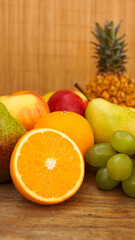 Spring or Summer concept. Many kinds of fruit. Vertical photo, can use for summer or food content background. Orange, apple, pineapple