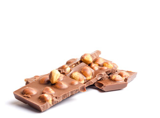 Pieces of chocolate with hazelnuts on a white background