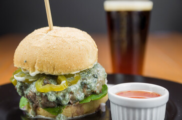 Close-up of tasty homemade hamburger on wooden table.