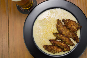Delicious chicken risotto dish with pieces of breaded chicken breast