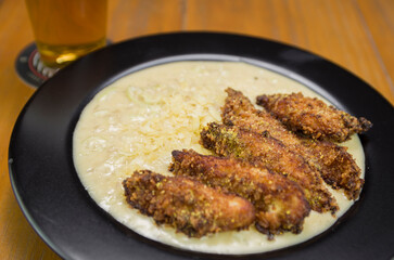 Delicious chicken risotto dish with pieces of breaded chicken breast