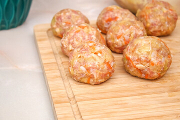 Lazy stuffed cabbage rolls, cabbage, rice on a wooden cutting board on the table. Meatballs with cabbage.