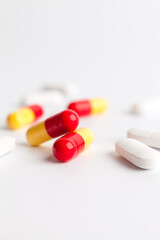Colorful and white pills on a white background