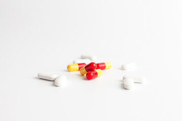 Colorful and white pills on a white background