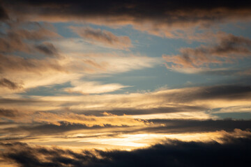 Fototapeta premium Sunset sky with orange clouds and blue sky