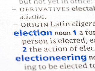 Election - English dictionary definition of the word - photo of a dictionary page with paper grain texture - selective focus on the word
