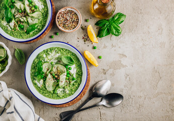 Cold green soup Gazpacho with cucumber, green peas, basil leaves and avocado.
