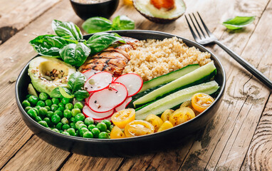 Healthy salad bowl with quinoa and chicken. Food and health.