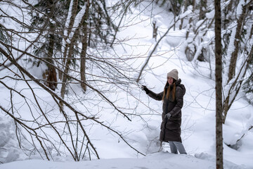 Girl walking in the snowy forest.