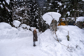 Girl walking in the snowy forest.
