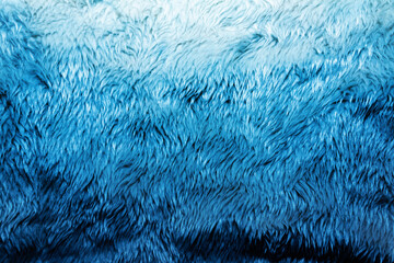 Backdrop close-up photo texture of blue colored fur material.