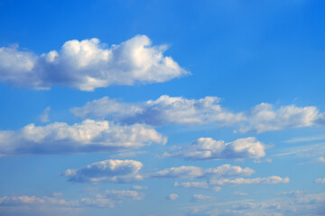 White clouds against a calm blue sky, summer cloudscape