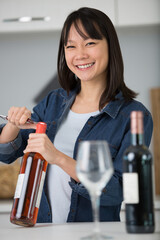 tasting exfemale sommelier uncorking a bottle of wine