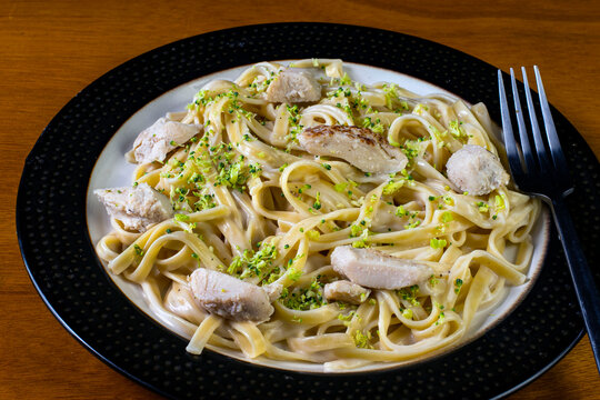 fettuccne top with broccoli and chicken in alfredo sauce