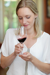 female sommelier smelling wine before drinking