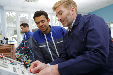 foreman explaining electronic controls to trainee